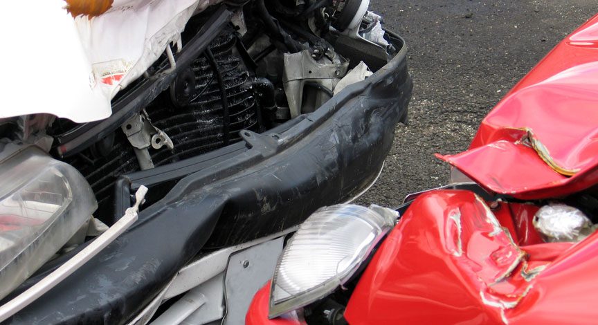 close-up-of-crumpled-front-end-damage-on-a-red-car-after-a-collision