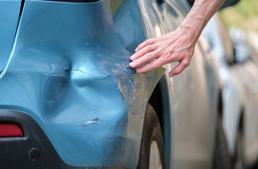 driver-touching-dent-after-hit-and-run