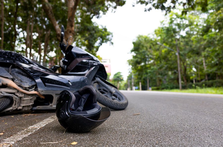 motorcycle-lying-on-the-ground-with-helmet-nearby