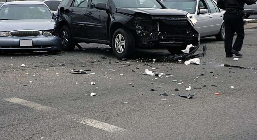two-damaged-cars-in-the-road-with-debris-scattered-after-a-crash