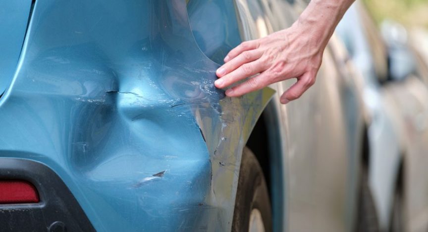 driver-touching-dent-after-hit-and-run