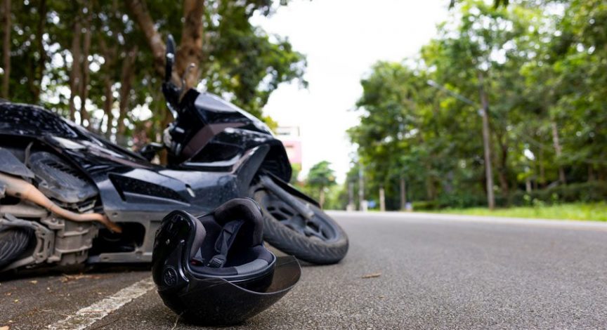 motorcycle-lying-on-the-ground-with-helmet-nearby